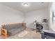 Bedroom featuring a futon, desk, and neutral carpeting at 9862 Reunion Pkwy, Commerce City, CO 80022
