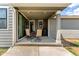 A covered patio with modern seating, offering a relaxing outdoor space at 9862 Reunion Pkwy, Commerce City, CO 80022