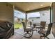Cozy covered patio with stylish furniture and outdoor lighting, perfect for entertaining at 9862 Reunion Pkwy, Commerce City, CO 80022