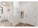 Hallway with laundry area and hooks for dog leash near door at 9862 Reunion Pkwy, Commerce City, CO 80022