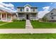 Charming two-story home with a well-manicured lawn and inviting front porch at 9862 Reunion Pkwy, Commerce City, CO 80022