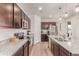 Modern kitchen with stainless steel appliances, granite counters, and dark wood cabinetry at 9862 Reunion Pkwy, Commerce City, CO 80022