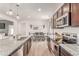 Well-appointed kitchen with stainless steel appliances, granite countertops, and stylish fixtures at 9862 Reunion Pkwy, Commerce City, CO 80022