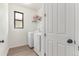 Bright laundry room featuring a washer, dryer, and window for natural light at 9862 Reunion Pkwy, Commerce City, CO 80022