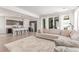 Open-concept living area with a comfortable sectional sofa and seamless flow to the kitchen at 9862 Reunion Pkwy, Commerce City, CO 80022