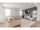 Bright and airy living room with plush seating, modern decor, and ample natural light at 9862 Reunion Pkwy, Commerce City, CO 80022