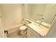 Cozy bathroom with tub, toilet, and vanity featuring a framed mirror at 10538 Tiger Chase, Lone Tree, CO 80124