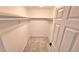 Walk-in closet featuring neutral carpet and open shelving for storage at 10538 Tiger Chase, Lone Tree, CO 80124