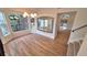 Bright dining room featuring large windows, wood floors, and modern chandelier at 10538 Tiger Chase, Lone Tree, CO 80124