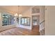 Bright dining room featuring large windows, wood floors, and modern chandelier at 10538 Tiger Chase, Lone Tree, CO 80124