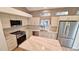 Bright kitchen features stainless steel appliances, white cabinets, and a center island with stone countertop at 10538 Tiger Chase, Lone Tree, CO 80124