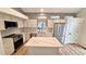 Modern kitchen featuring stainless steel appliances, white cabinetry, and center island at 10538 Tiger Chase, Lone Tree, CO 80124