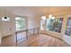 Bright living room featuring vaulted ceilings, large windows, wood floors, and modern chandelier at 10538 Tiger Chase, Lone Tree, CO 80124
