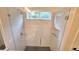 Modern shower with glass door, window, and sleek tile design at 10538 Tiger Chase, Lone Tree, CO 80124