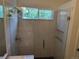 Bathroom featuring tiled shower with glass door, shower head, and light-colored countertops at 10538 Tiger, Lone Tree, CO 80124