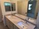 Bright bathroom featuring double sinks with stone countertop and view to bedroom at 10538 Tiger, Lone Tree, CO 80124