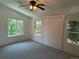 Bedroom with neutral walls and carpet, with ceiling fan and multiple windows at 10538 Tiger, Lone Tree, CO 80124