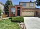 A stunning two-story home with a brick facade, a two-car garage, and mature front yard landscaping at 10538 Tiger, Lone Tree, CO 80124