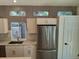 Modern kitchen featuring stainless steel appliances, granite countertops, a center island, and lots of natural light at 10538 Tiger, Lone Tree, CO 80124