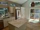 Modern kitchen featuring stainless steel appliances, granite countertops, a center island, and lots of natural light at 10538 Tiger, Lone Tree, CO 80124