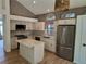 Modern kitchen featuring stainless steel appliances, granite countertops, a center island, and lots of natural light at 10538 Tiger, Lone Tree, CO 80124