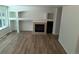 Living room featuring wood floors, fireplace, built-in shelving, and a large window at 10538 Tiger, Lone Tree, CO 80124