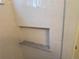 Tiled shower niche featuring elegant white subway tile and marble shelf at 10538 Tiger, Lone Tree, CO 80124