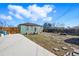 View of the backyard with wood fence, patio with furniture, and green house at 1730 W 51St Ave, Denver, CO 80221