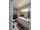 Well-lit bathroom with a large mirror, white vanity, and shower-tub combo at 14201 E 1St Dr # 104, Aurora, CO 80011