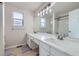 Bathroom featuring a double sink vanity with modern fixtures and a large mirror at 19372 E 41St Ave, Denver, CO 80249