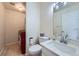 Bathroom with modern vanity, sink, toilet, and red washing machine in the corner at 19372 E 41St Ave, Denver, CO 80249