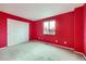 Bedroom with bright red walls, a window, and a closet at 19372 E 41St Ave, Denver, CO 80249