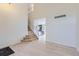Bright entryway features hardwood floors, stairs to the upper level, and an open view into the kitchen at 19372 E 41St Ave, Denver, CO 80249