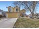 Two-story home featuring a manicured lawn, a two-car garage, and charming curb appeal at 19372 E 41St Ave, Denver, CO 80249