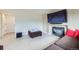Bright living room with fireplace, mounted television, and hardwood floors at 19372 E 41St Ave, Denver, CO 80249