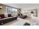 Bright living room with a large window, neutral walls, and seamless access to the adjacent kitchen area at 19372 E 41St Ave, Denver, CO 80249