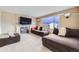 Cozy living room with a tile fireplace, large windows, and neutral paint, flowing into the dining area at 19372 E 41St Ave, Denver, CO 80249