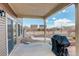 Cozy backyard patio with sliding glass doors and a grill, perfect for outdoor entertaining at 4971 Ceylon Way, Denver, CO 80249