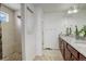 Bathroom with double sinks, granite counters, tiled floors, and a walk-in shower at 4971 Ceylon Way, Denver, CO 80249