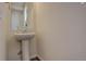 Simple powder room with a pedestal sink, modern fixtures, and a clean, minimalist design at 4971 Ceylon Way, Denver, CO 80249