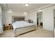 Spacious bedroom featuring a large bed, ample space, and a connected bathroom at 4971 Ceylon Way, Denver, CO 80249