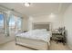 Bedroom with natural light from large window, tray ceiling and neutral walls at 4971 Ceylon Way, Denver, CO 80249