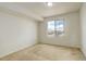 Neutral bedroom with tan carpet and a bright window at 4971 Ceylon Way, Denver, CO 80249