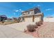 Well-maintained home with lush landscaping, stone accents, and an oversized driveway with a three car garage at 4971 Ceylon Way, Denver, CO 80249