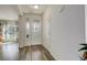 Bright foyer features stylish flooring, a decorative front door, and a glimpse into the adjacent living space at 4971 Ceylon Way, Denver, CO 80249