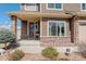 Charming front porch with stone accents, a welcoming entrance, and beautifully landscaped surroundings at 4971 Ceylon Way, Denver, CO 80249