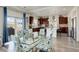 Bright, open kitchen and dining area featuring a large island, modern appliances, and stylish floral dining chairs at 4971 Ceylon Way, Denver, CO 80249