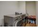 Functional laundry room with a side-by-side washer and dryer and a storage area at 4971 Ceylon Way, Denver, CO 80249