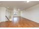 Expansive living room featuring hardwood floors, a staircase, and an abundance of natural light at 4971 Ceylon Way, Denver, CO 80249