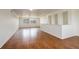 Spacious living room featuring hardwood floors, natural light from large windows, and neutral wall paint at 4971 Ceylon Way, Denver, CO 80249